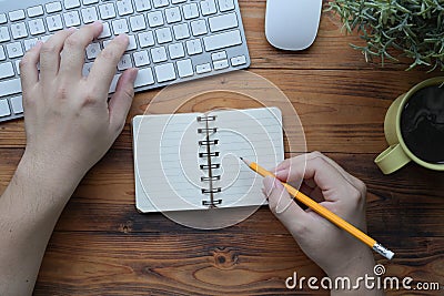 Creative man holding pencil making note on notebook. Stock Photo