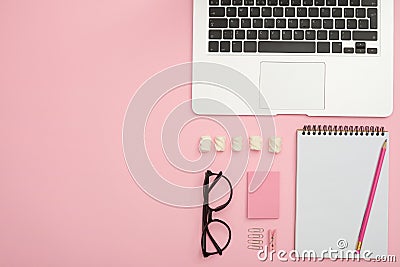Feminine work desk of orderly person with laptop, glasses, jotte Stock Photo
