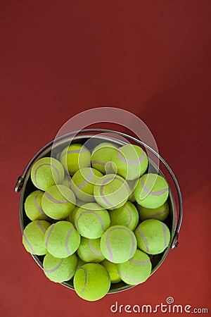 Overhead view of fluorescent yellow tennis balls in bucket Stock Photo