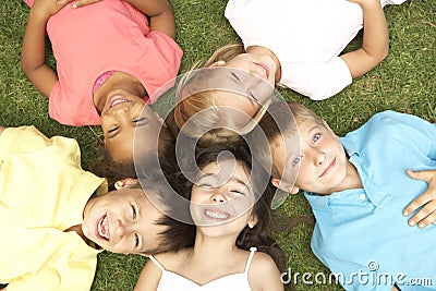 Overhead View Of Group Of Children Smiling At Camera Stock Photo