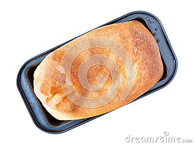 Overhead view of a loaf of homemade bread in a gray metal pan at an angle isolated on a white background Stock Photo