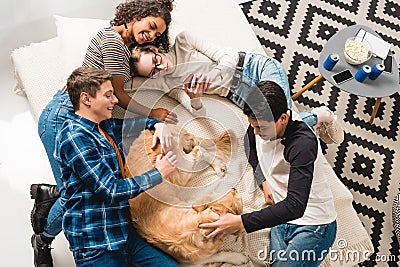 overhead view of multicultural teens lying on bed Stock Photo