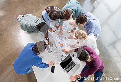 Overhead view of professional businesspeople discussing and brainstorming together Stock Photo