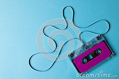 Overhead view of purple cassette tape with copy space on blue background Stock Photo