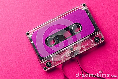 Overhead view of purple cassette tape on pink background Stock Photo