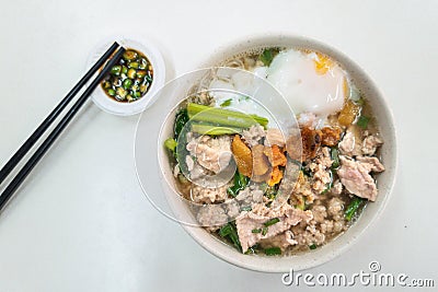 Overhead view of simple Chinese pork noodle soup with eggs served with lard and chili pepper Stock Photo