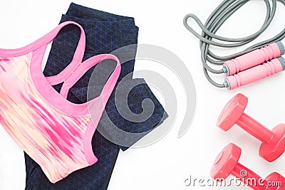 Overhead view of sport bra, fitness legging and sport equipments on white background Stock Photo