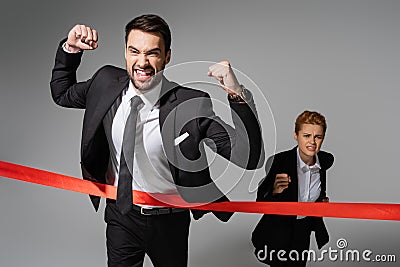 overjoyed businessman in black suit showing Stock Photo