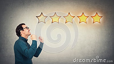 Overjoyed businessman keeps fists tight, celebrate success achievement, as receives positive feedback and approval. Boss, company Stock Photo