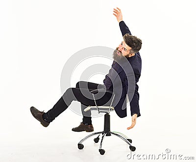 Overjoyed businessman riding in an office chair Stock Photo