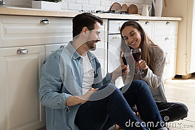 Overjoyed couple sit on floor celebrate anniversary together Stock Photo