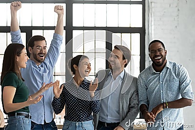 Overjoyed happy diverse business team celebrating success together Stock Photo