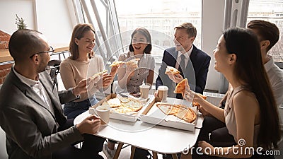 Overjoyed happy mixed race company employees celebrating special occasion. Stock Photo