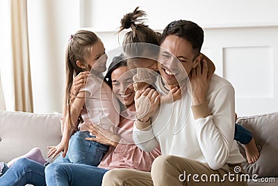 Overjoyed little children playing with happy parents. Stock Photo