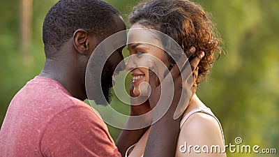 Overjoyed lovers hug one another delightfully, look at each other sensually Stock Photo