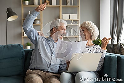 Happy elderly spouses clients excited with easy online payment Stock Photo