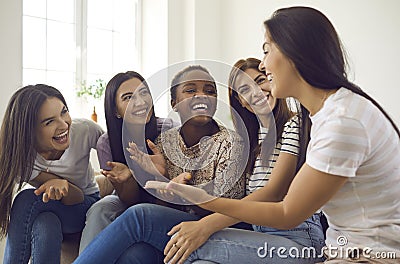 Overjoyed millennial diverse girls relax together at home Stock Photo