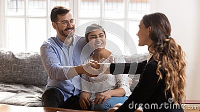 Smiling millennial couple handshake female specialist at meeting Stock Photo