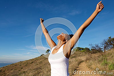 Overjoyed woman outdoors with her arms wide open Stock Photo