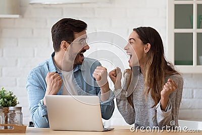 Overjoyed young family spouse celebrating online lottery win. Stock Photo