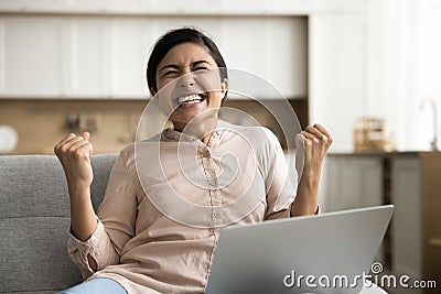 Overjoyed young freelance business woman celebrating triumph Stock Photo