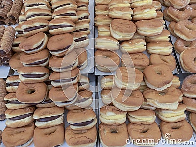 Overlapping trays full of stuffed donuts. Stock Photo