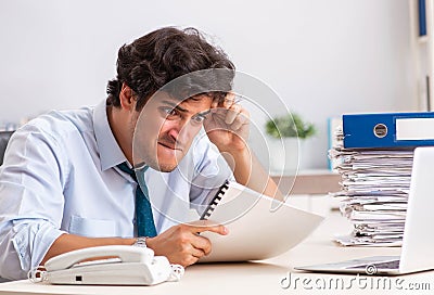 Overloaded busy employee with too much work and paperwork Stock Photo