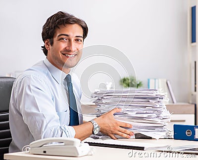 Overloaded busy employee with too much work and paperwork Stock Photo