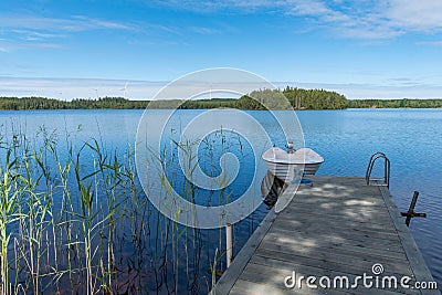 Overlooking a boat jetty and a lake Stock Photo