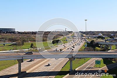 Overlooking an on and off ramp interstate highway exchange with multiple lanes below and blue sky Editorial Stock Photo