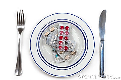 Overmedication -Capsules and hidden in a plate-Conceptual photo. Stock Photo