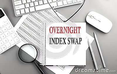 Overnight Index Swap text on notepad on chart with keyboard and calculator on grey background Stock Photo
