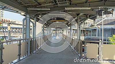 Overpass, connecting walkway for the BTS Skytrain, gray stone tile floor. There was a strong iron railing. Stock Photo