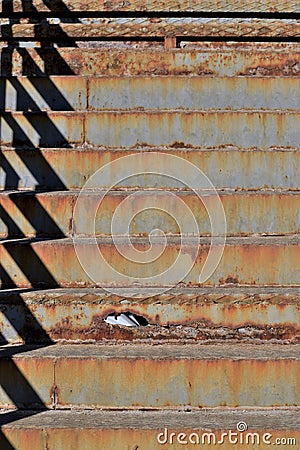 Hole in stairs shows crumbling infrastructure Stock Photo