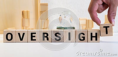 Oversight concept, word Oversight on wooden block Stock Photo