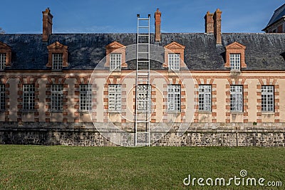 Oversized ladder on french country castle aisle Stock Photo