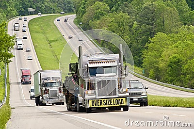 Oversized Load Traveling Down Highway Stock Photo