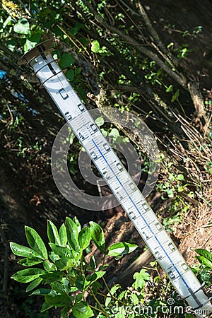 Oversized quicksilver thermometer in the blazing sun Stock Photo