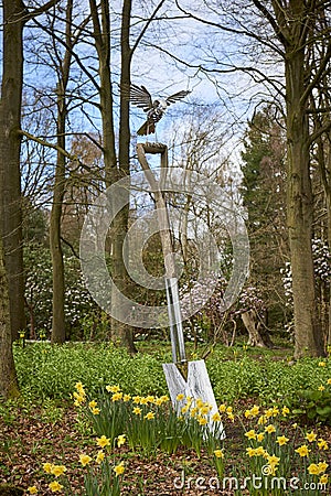 An oversized spade sculpture with a metal Bird alighting on it, one of the many Horticultural sculptures at Harlow Carr. Stock Photo