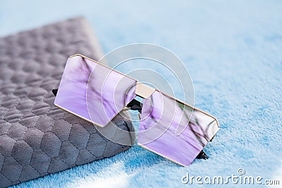 Oversized sunglasses model with pink flat lenses shoot outside in a sunny day closeup . Selective focus Stock Photo