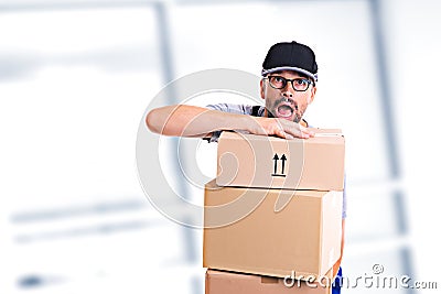 Overstrained postman with parcels Stock Photo