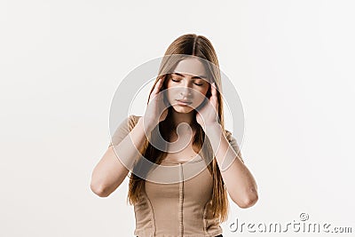 Overstressed young woman with head pain touches head. Depression. Sad woman with migraine strong headache disease. Stock Photo
