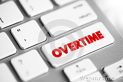 Overtime - amount of time someone works beyond normal working hours, text button on keyboard Stock Photo
