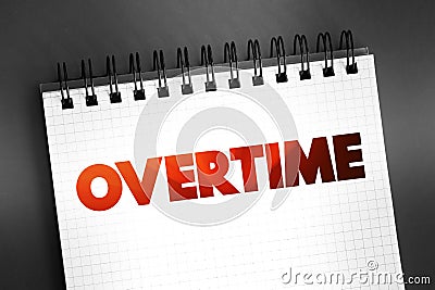 Overtime - amount of time someone works beyond normal working hours, text on notepad concept background Stock Photo
