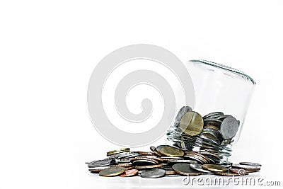 Overturn glass jar with coins spilled out, on white background Stock Photo