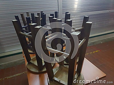 Overturn stool on wooden table Stock Photo