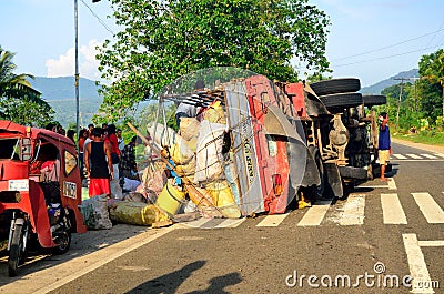Overturned truck on road in Mindinao with bystanders Editorial Stock Photo