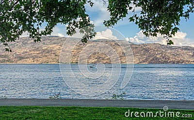 Overview of Okanagan lake with a boat and waterskiing man on the water Stock Photo