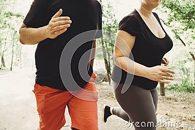 Overweight couple losing weight running together Stock Photo