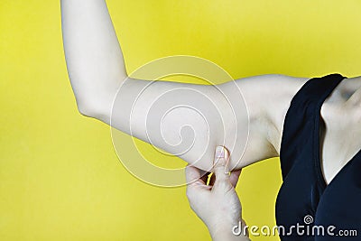 Overweight fat woman, Middle-aged woman checking her flabby excessive fat arm. Stock Photo
